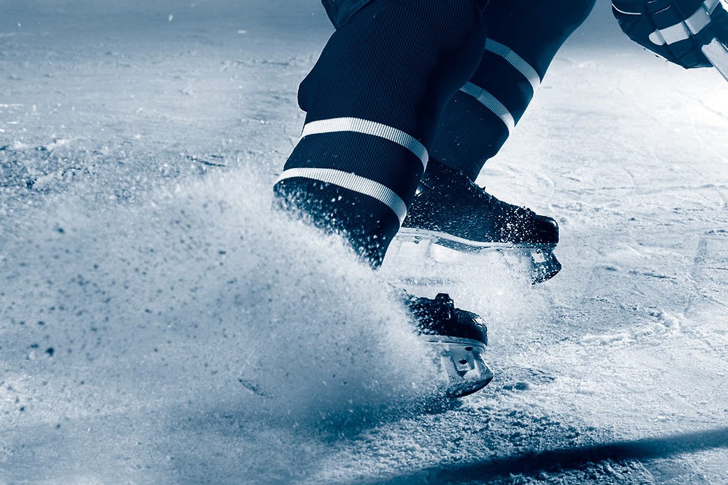 Hockey player skating on ice, close-up.