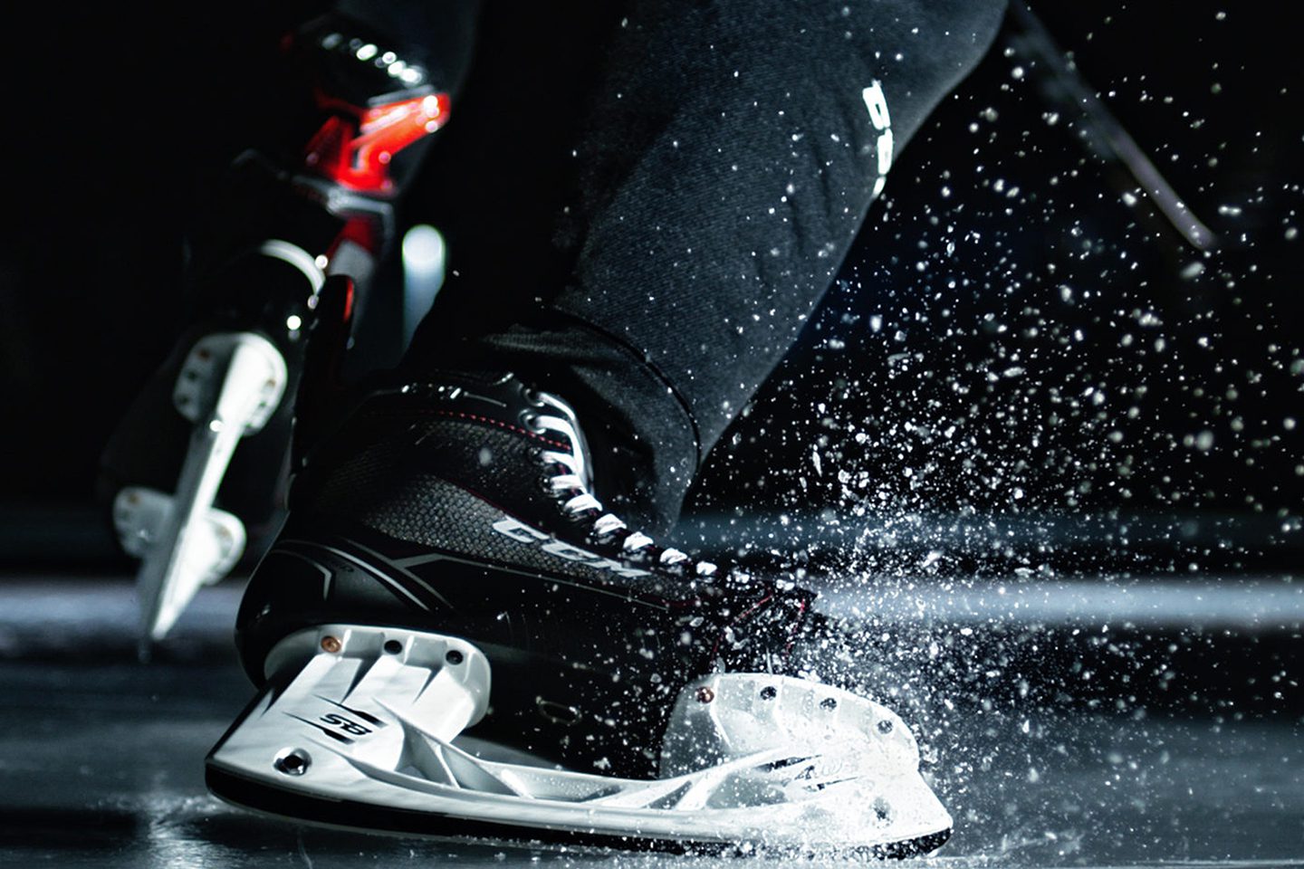 Ice skates cutting across frozen surface.