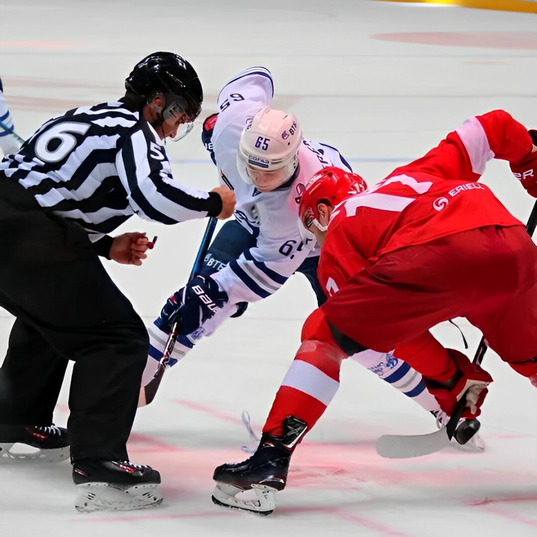 Ice hockey face-off between two players.
